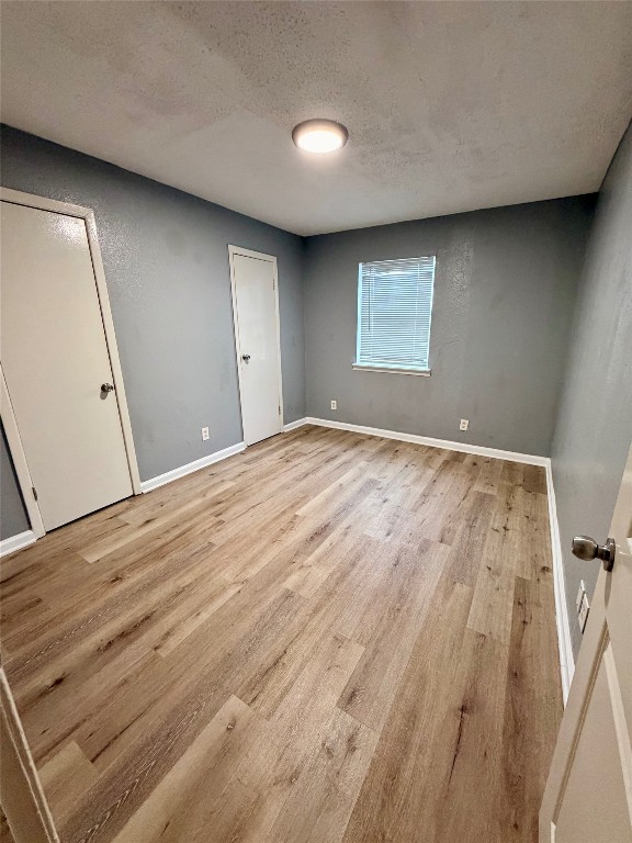 9100 Dodson Street, Unit 19 Houston, TX 77093 - Photo 9 of 16 a view of empty room with wooden floor