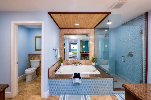 a bathroom with a tub sink and mirror