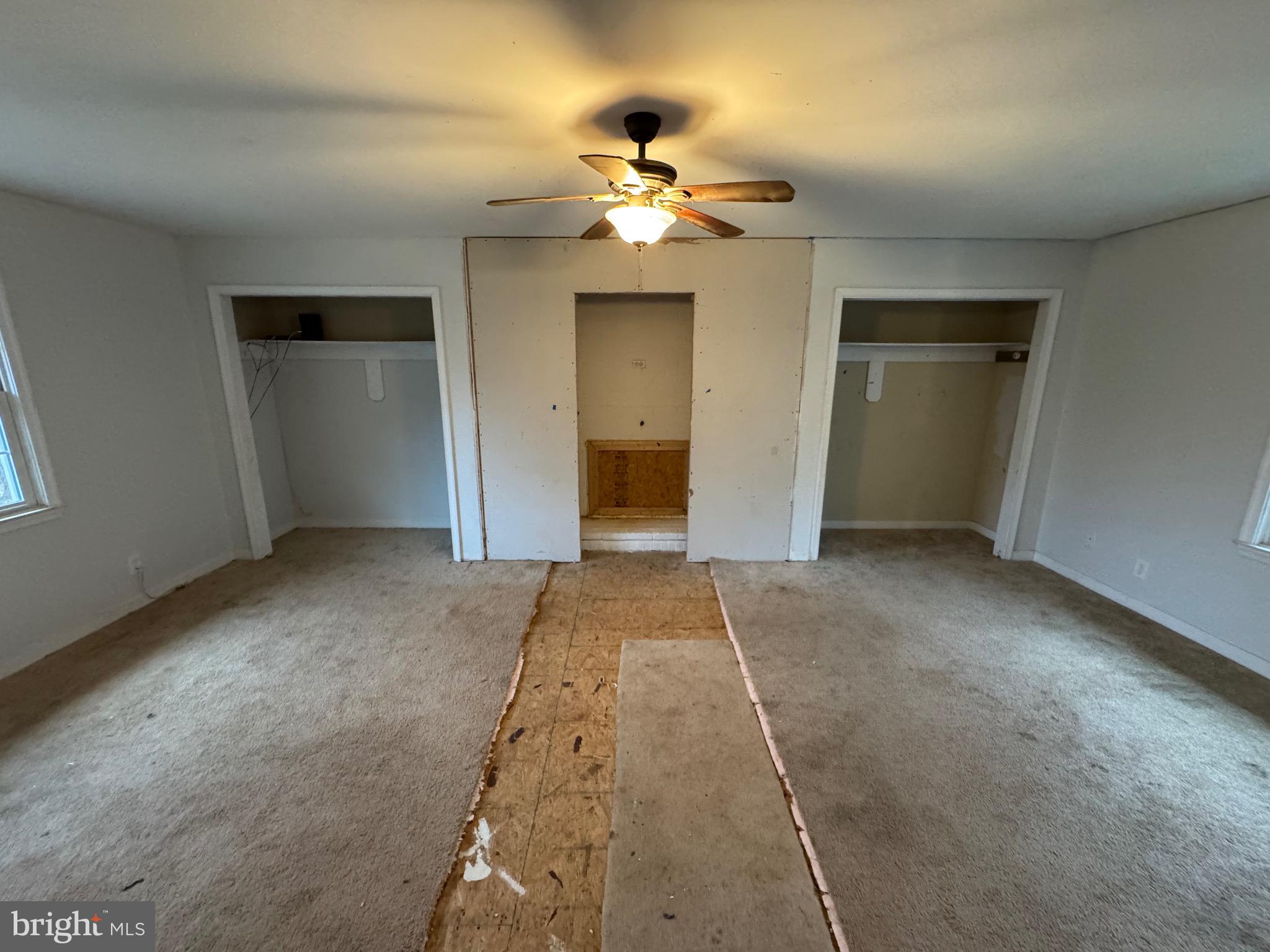 307 Dan Hall Road Mineral, VA 23117 - Photo 24 of 36 an empty room with chandelier fan and kitchen view