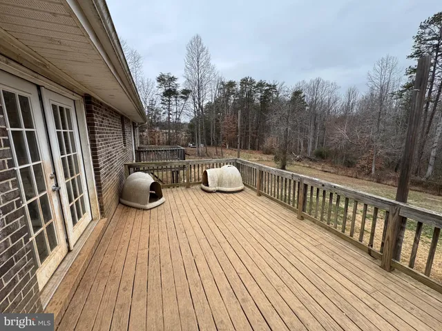 a view of a balcony with wooden floor and outdoor seating