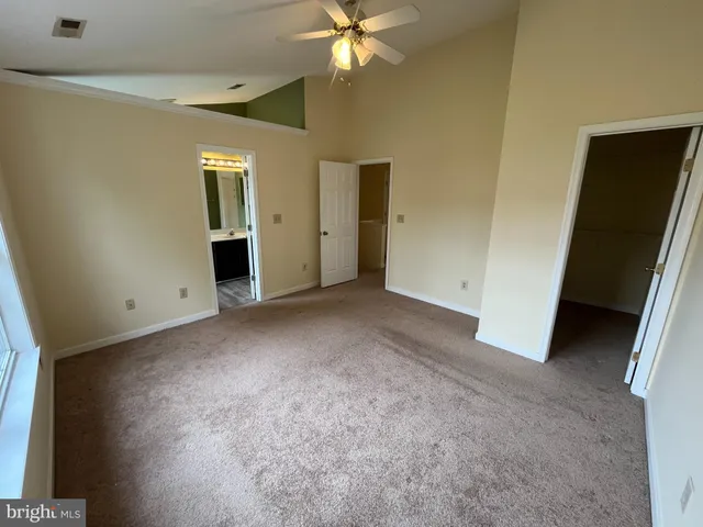 a view of a livingroom with a ceiling fan and window