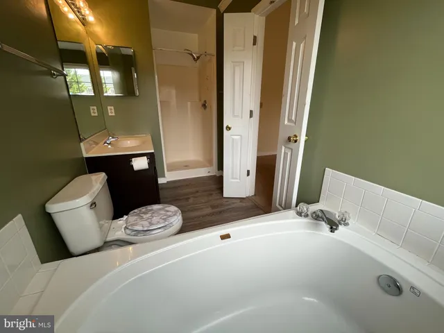 a bedroom with a bed and a mirror