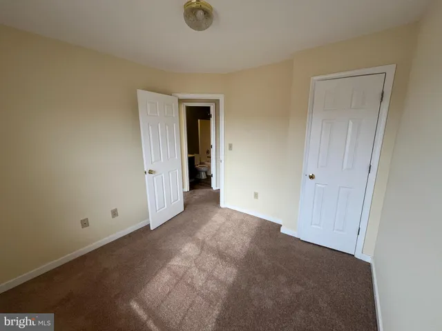 an empty room with closet area