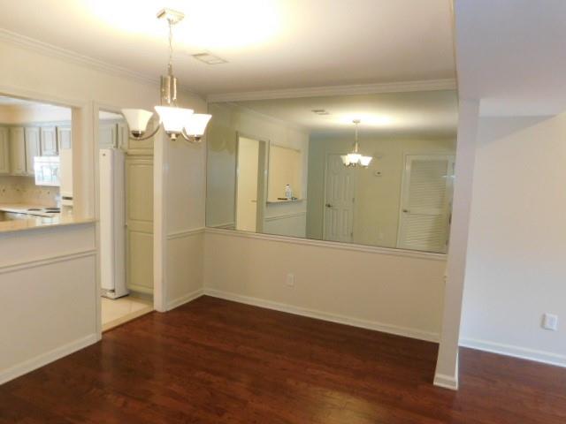 1245 South Ponce De Leon Avenue Northeast, Unit C2 Atlanta, GA 30306 - Photo 12 of 27 a view of a hallway with wooden floor chandelier and refrigerator