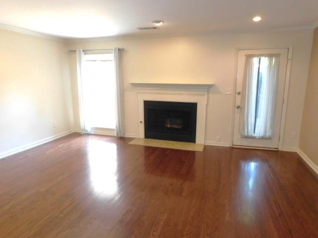 1245 South Ponce De Leon Avenue Northeast, Unit C2 Atlanta, GA 30306 - Photo 13 of 27 an empty room with wooden floor fireplace and windows