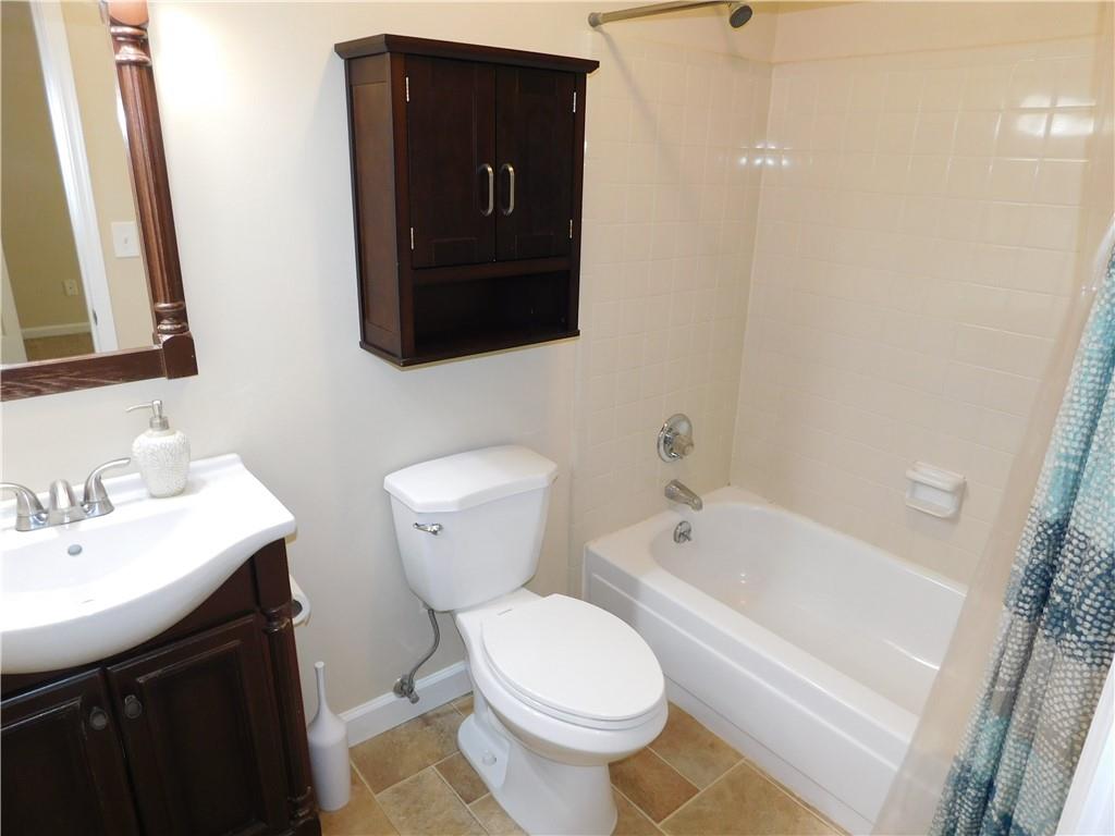 1245 South Ponce De Leon Avenue Northeast, Unit C2 Atlanta, GA 30306 - Photo 22 of 27 a bathroom with a toilet sink and mirror