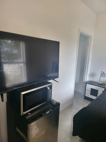 a bedroom with a bed and a night stand