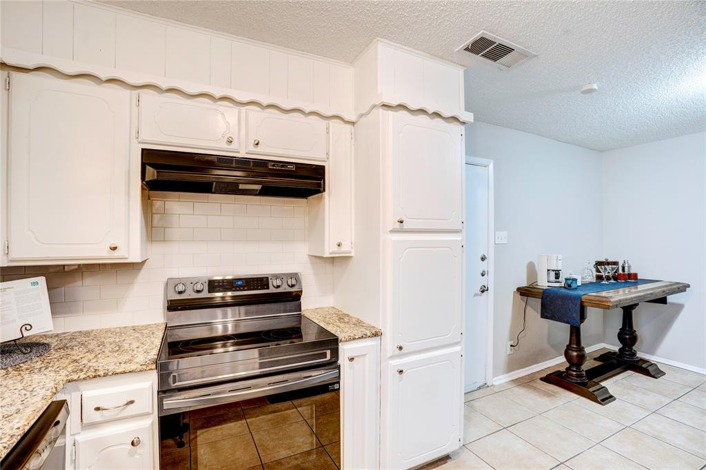 6028 Ridgecrest Drive Watauga, TX 76148 - Photo 12 of 40 a kitchen with a stove and a refrigerator