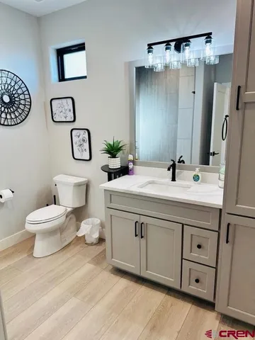 a bathroom with a toilet sink and a mirror