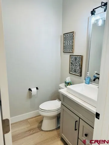a white toilet sitting next to a white sink