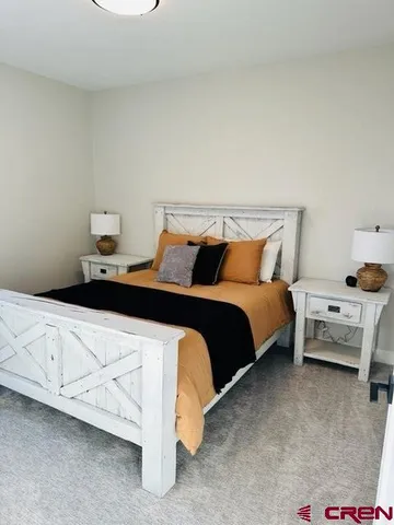 a bedroom with a bed and dresser