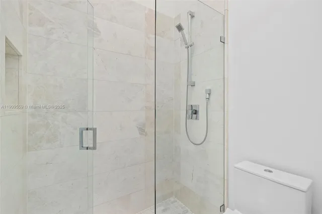 a view of an empty room with a window and a flat screen tv