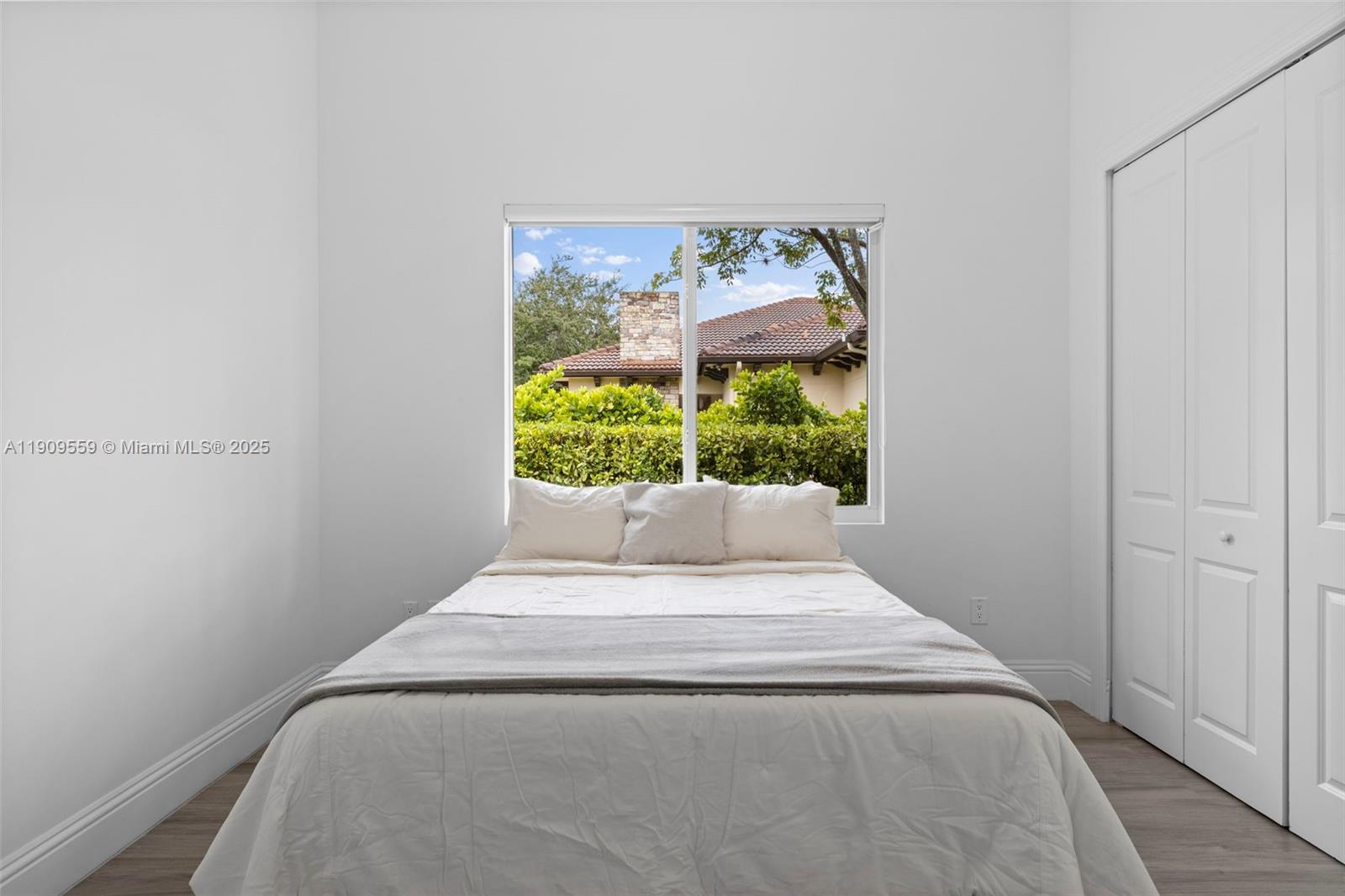 9580 Southwest 101st Terrace Miami, FL 33176 - Photo 33 of 88 a bed sitting in a bedroom next to a window