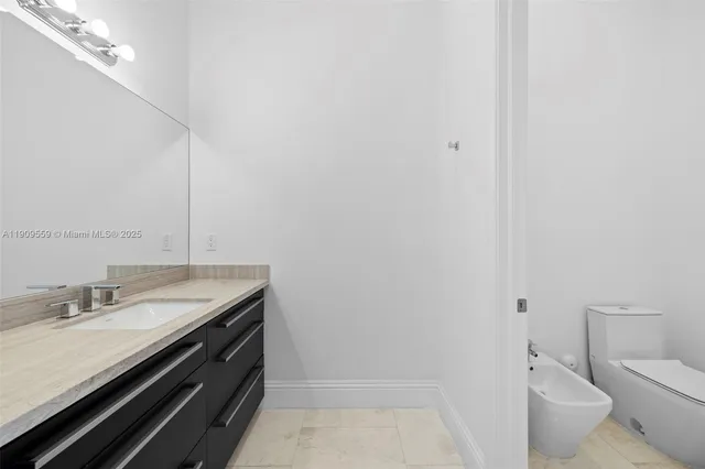 a view of a hallway with wooden floor and a living room
