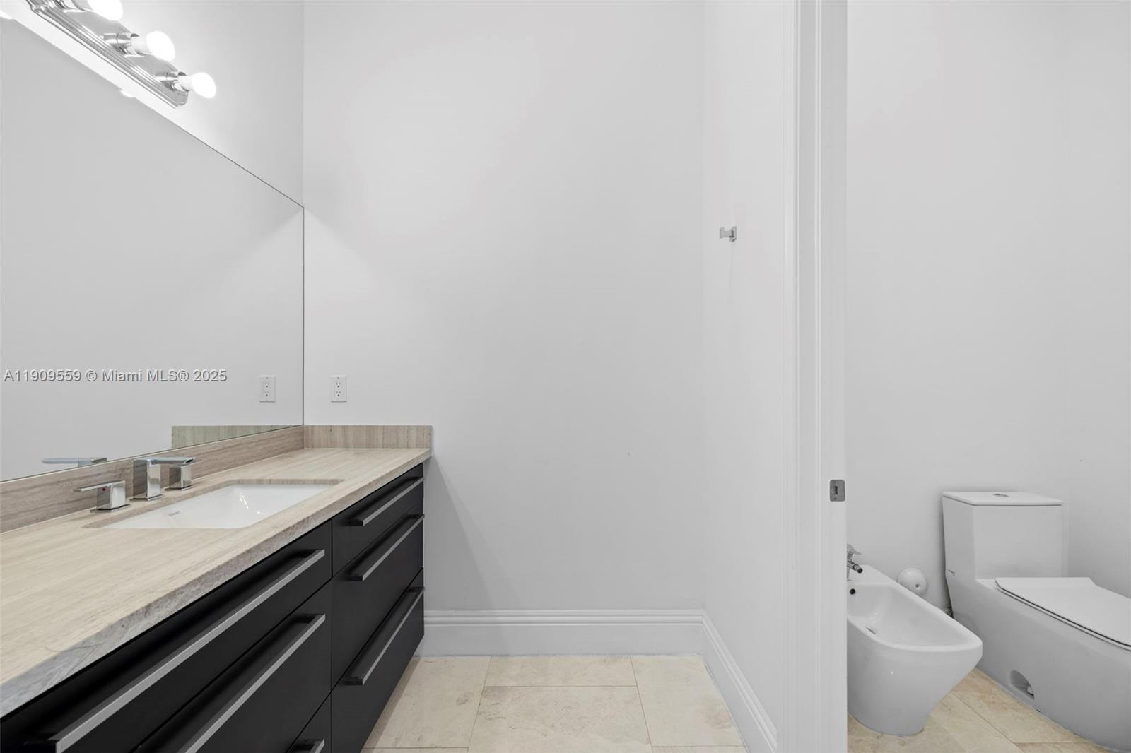 9580 Southwest 101st Terrace Miami, FL 33176 - Photo 41 of 88 a bathroom with a granite countertop sink a toilet and a mirror