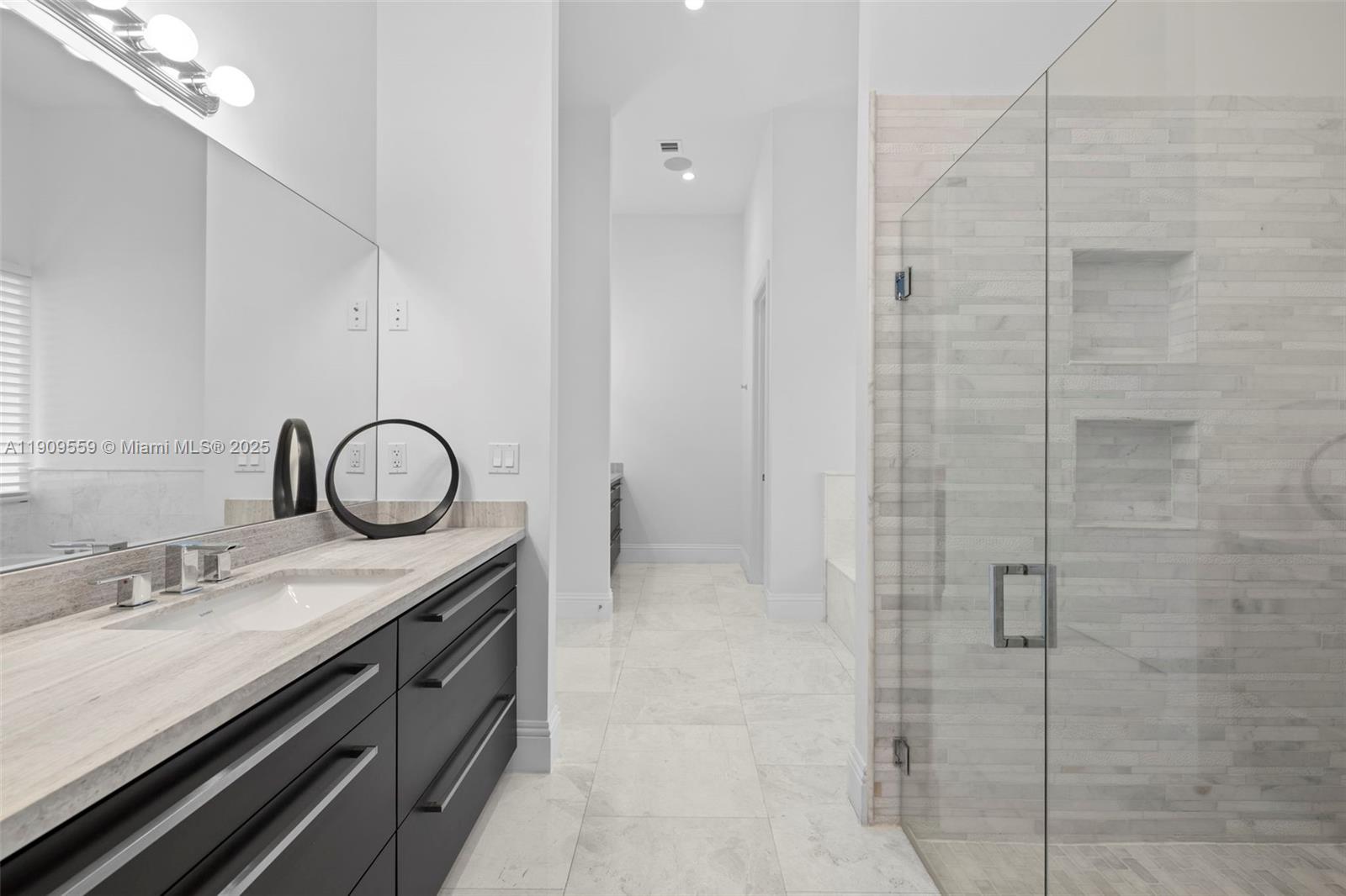 9580 Southwest 101st Terrace Miami, FL 33176 - Photo 42 of 88 a spacious bathroom with a granite countertop sink a mirror and shower