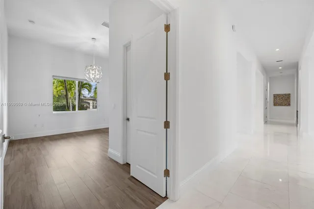 an aerial view of residential houses with outdoor space and trees