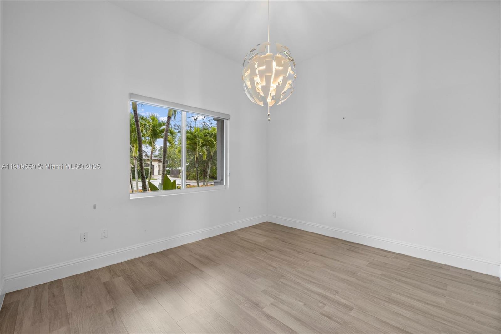 9580 Southwest 101st Terrace Miami, FL 33176 - Photo 49 of 88 an empty room with wooden floor and a window