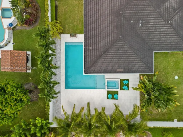 a view of swimming pool with a table and chairs