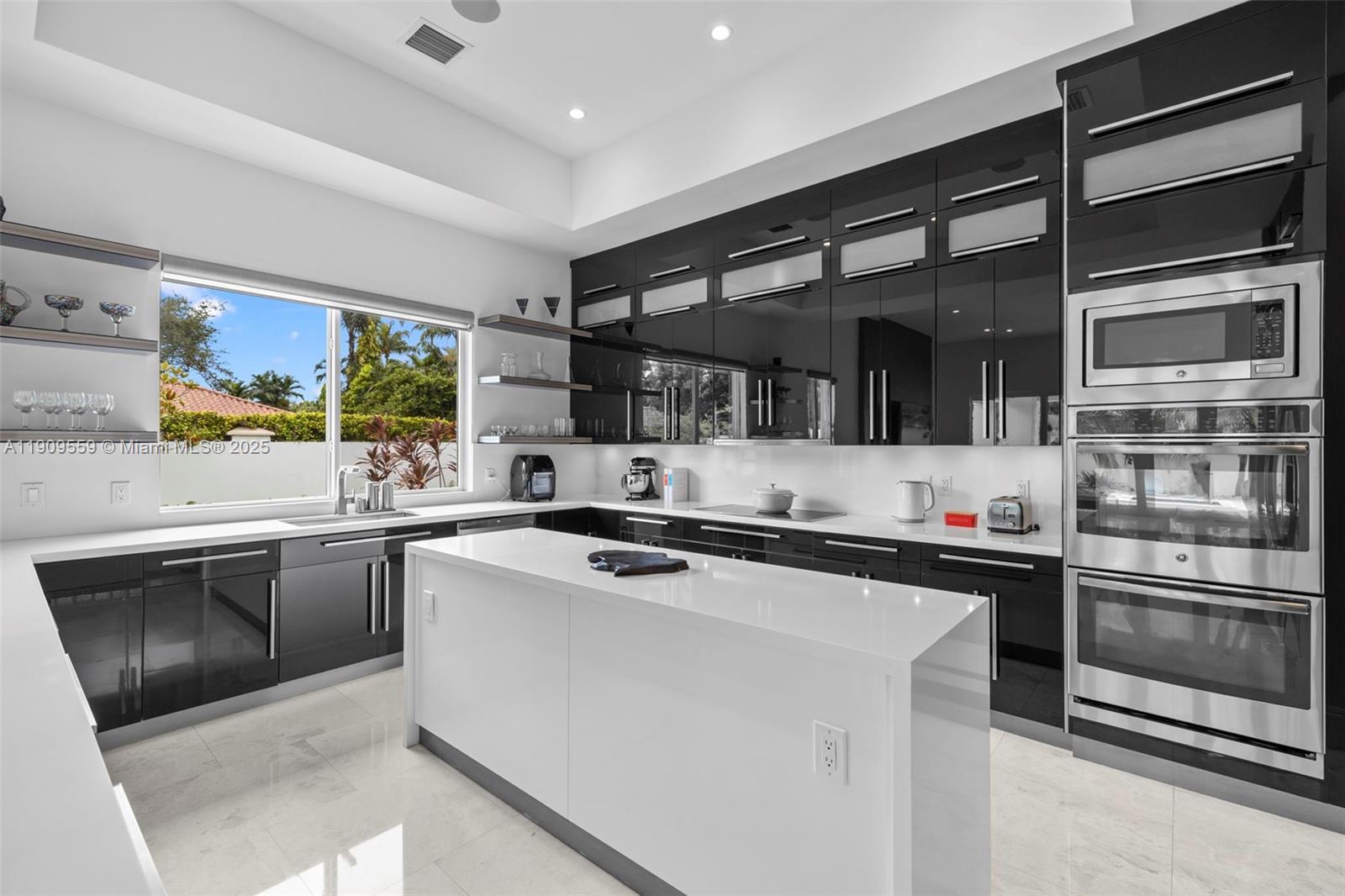 9580 Southwest 101st Terrace Miami, FL 33176 - Photo 67 of 88 a kitchen with stainless steel appliances a stove sink and cabinets