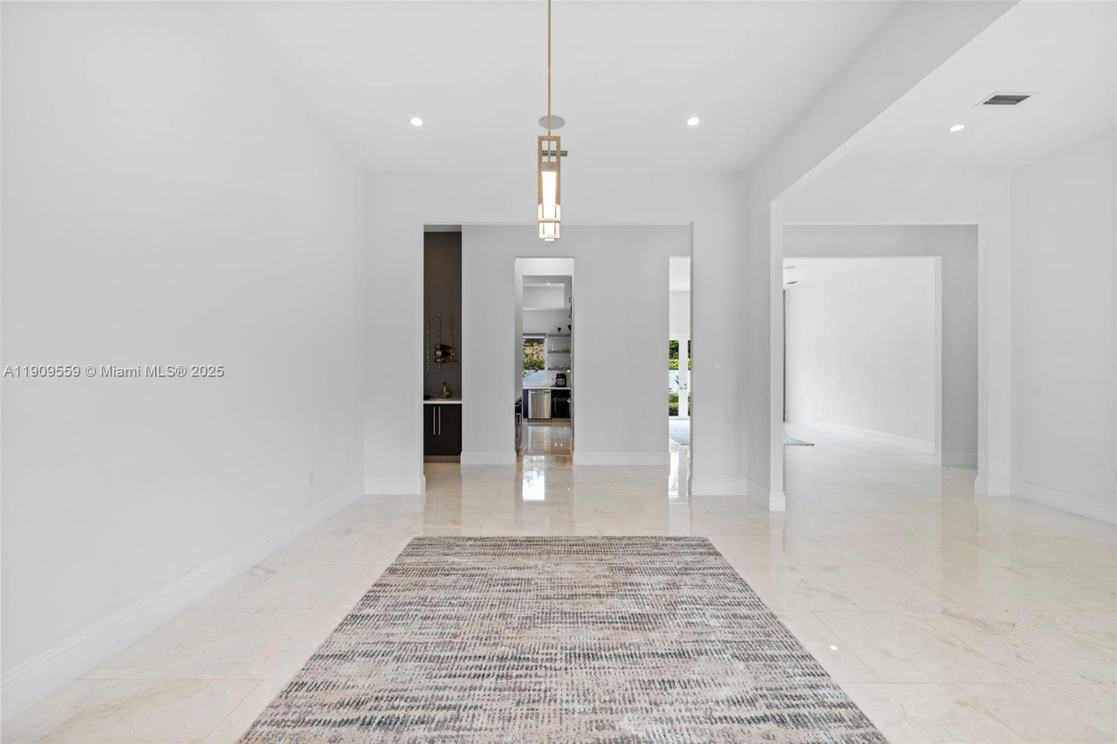 9580 Southwest 101st Terrace Miami, FL 33176 - Photo 78 of 88 a view of a hallway with wooden floor and a chandelier