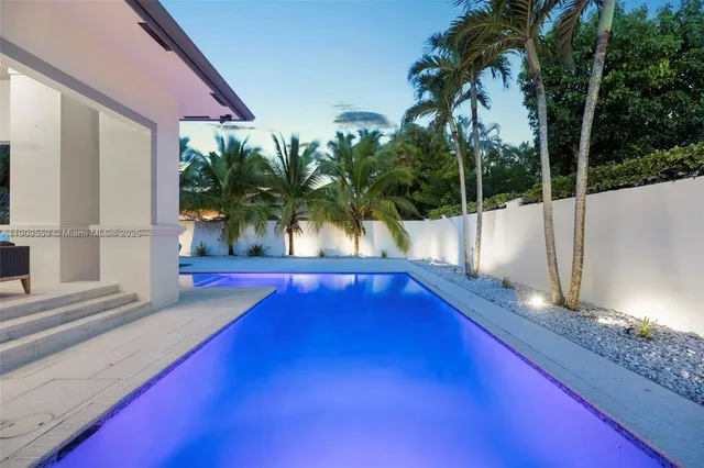a view of a house with backyard and swimming pool