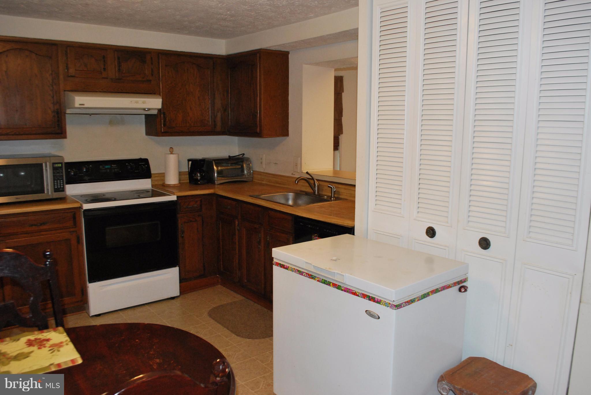 6900 Villa-Del-Rey Court Springfield, VA 22150 - Photo 9 of 29 a kitchen with a sink and a stove top oven