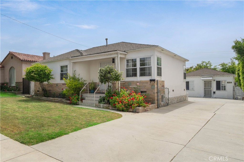a front view of a house with a garden