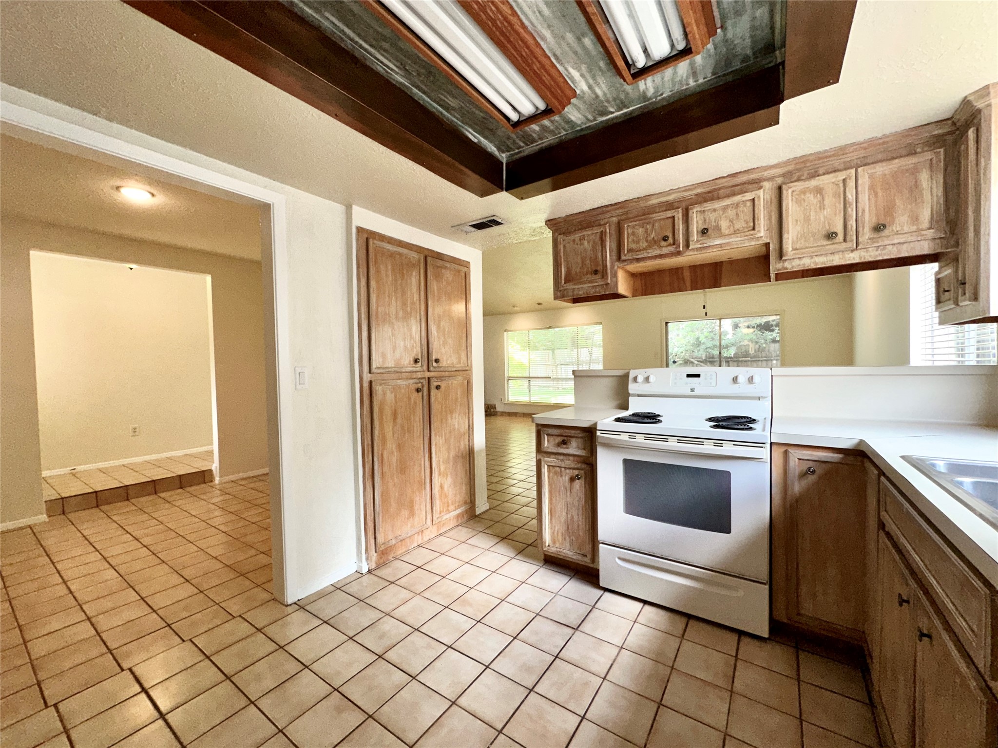8511 Little River Road Houston, TX 77064 - Photo 4 of 19 a kitchen with stainless steel appliances granite countertop a stove a sink and a refrigerator