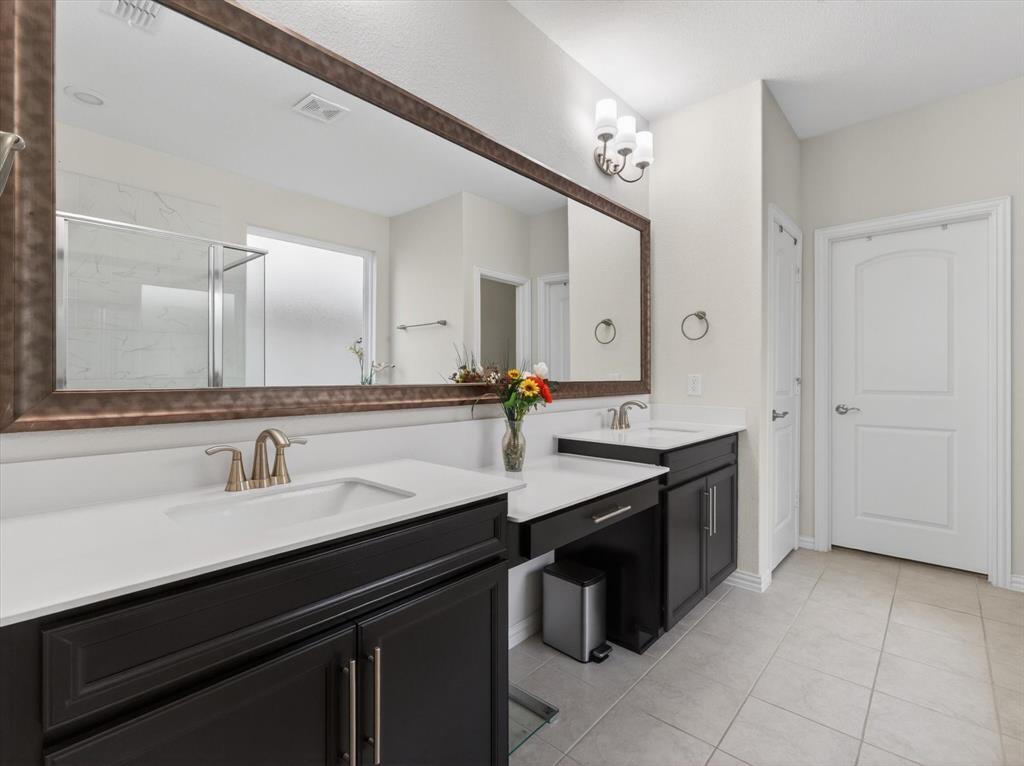 636 Corner Post Path Celina, TX 75009 - Photo 19 of 40 Spacious bathroom featuring a dual vanity with dark wood cabinetry and white countertops