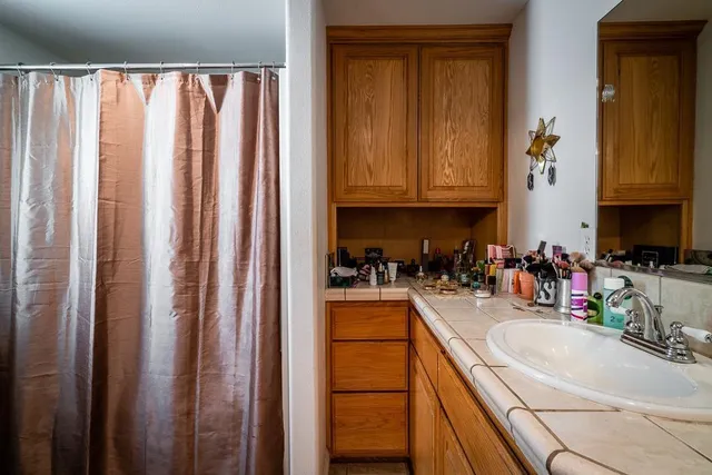 a kitchen with sink a refrigerator and cabinets