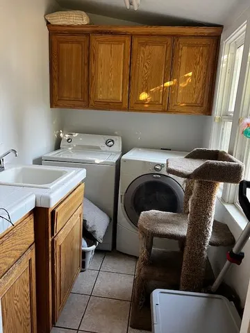 a utility room with a sink a washer and dryer