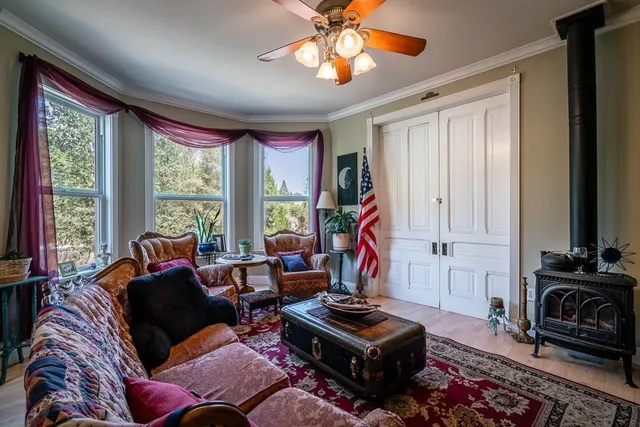 a living room with furniture a flat screen tv and a large window