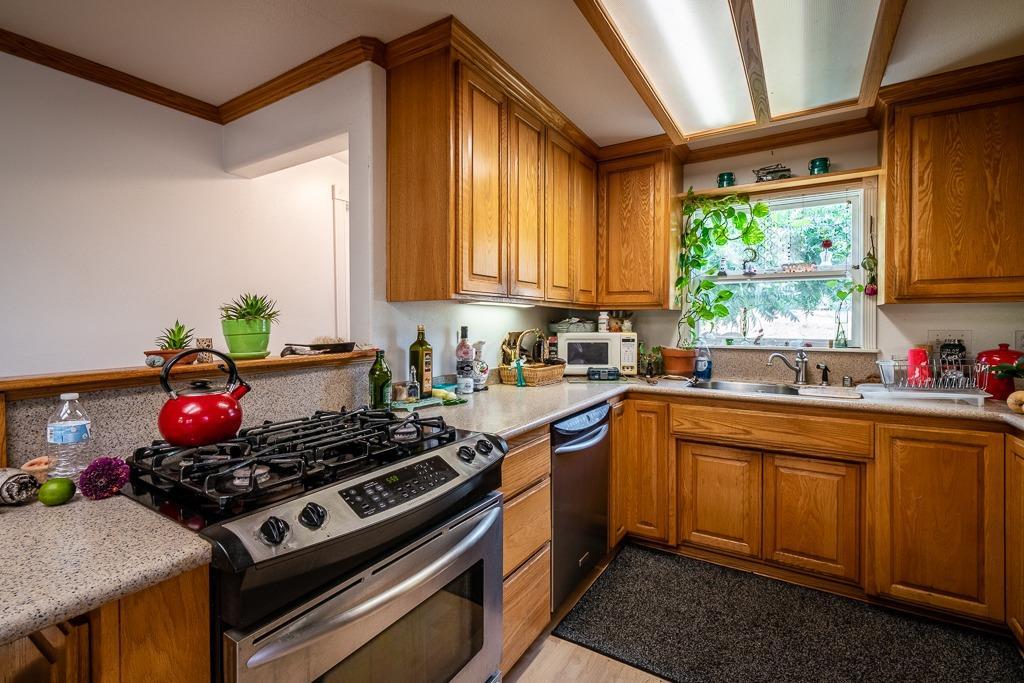 745 North Main Street Jackson, CA 95642 - Photo 9 of 25 a kitchen with a stove a sink and a window