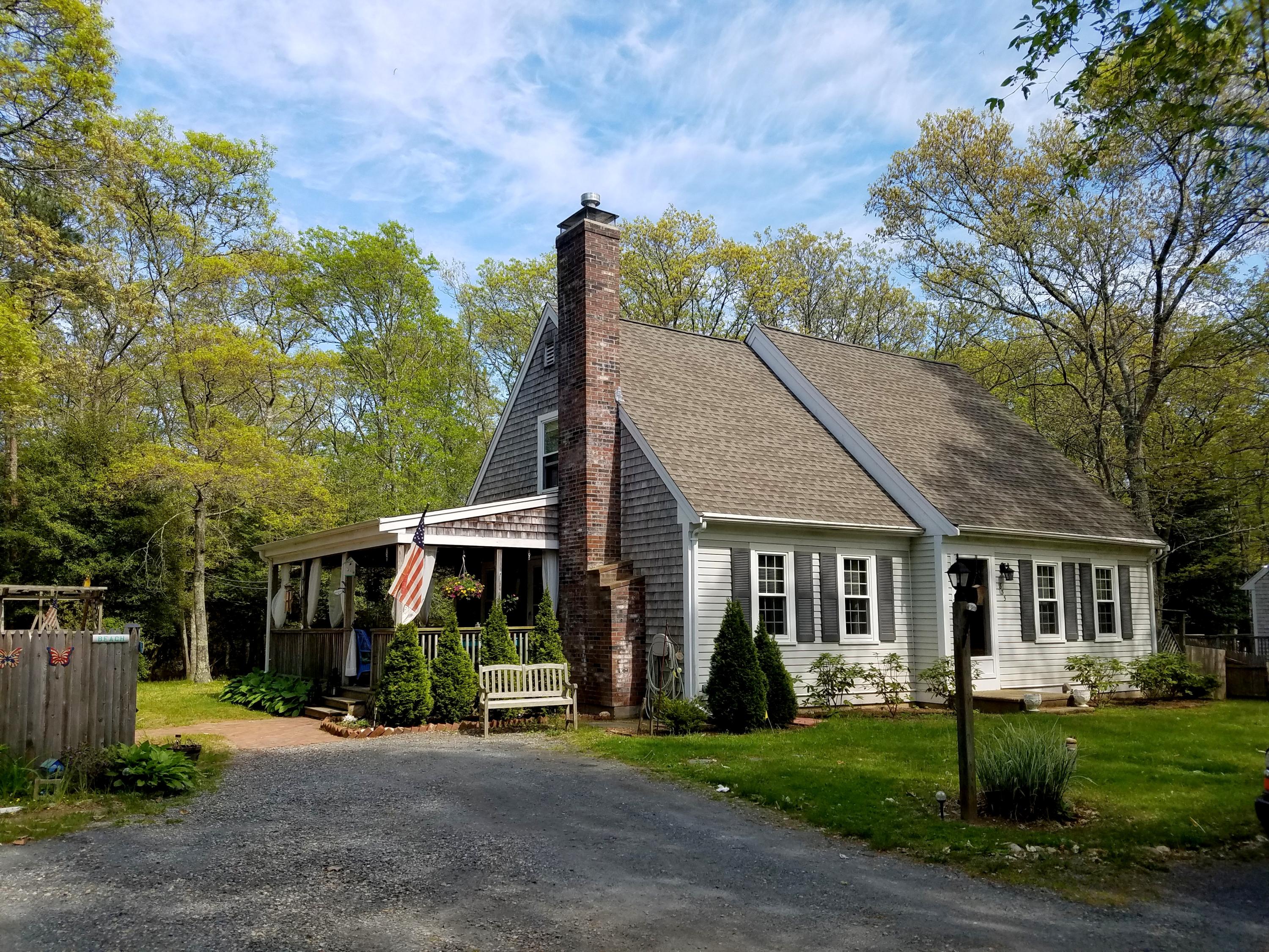 835 Cotuit Road Mashpee, MA 02649 - Photo 1 of 14 a view of a brick house with a big yard plants and large trees
