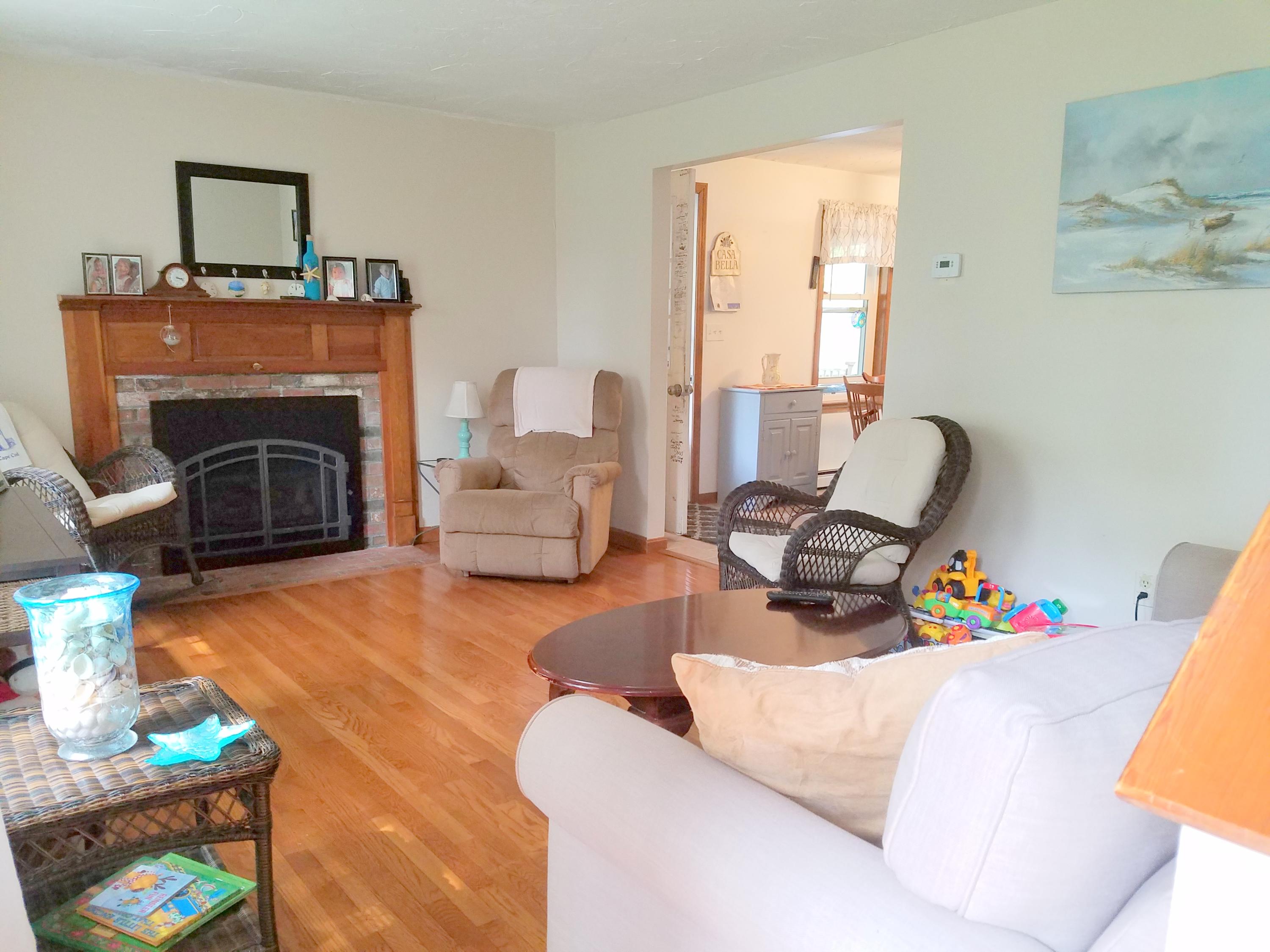 835 Cotuit Road Mashpee, MA 02649 - Photo 14 of 14 a living room with furniture and a fireplace