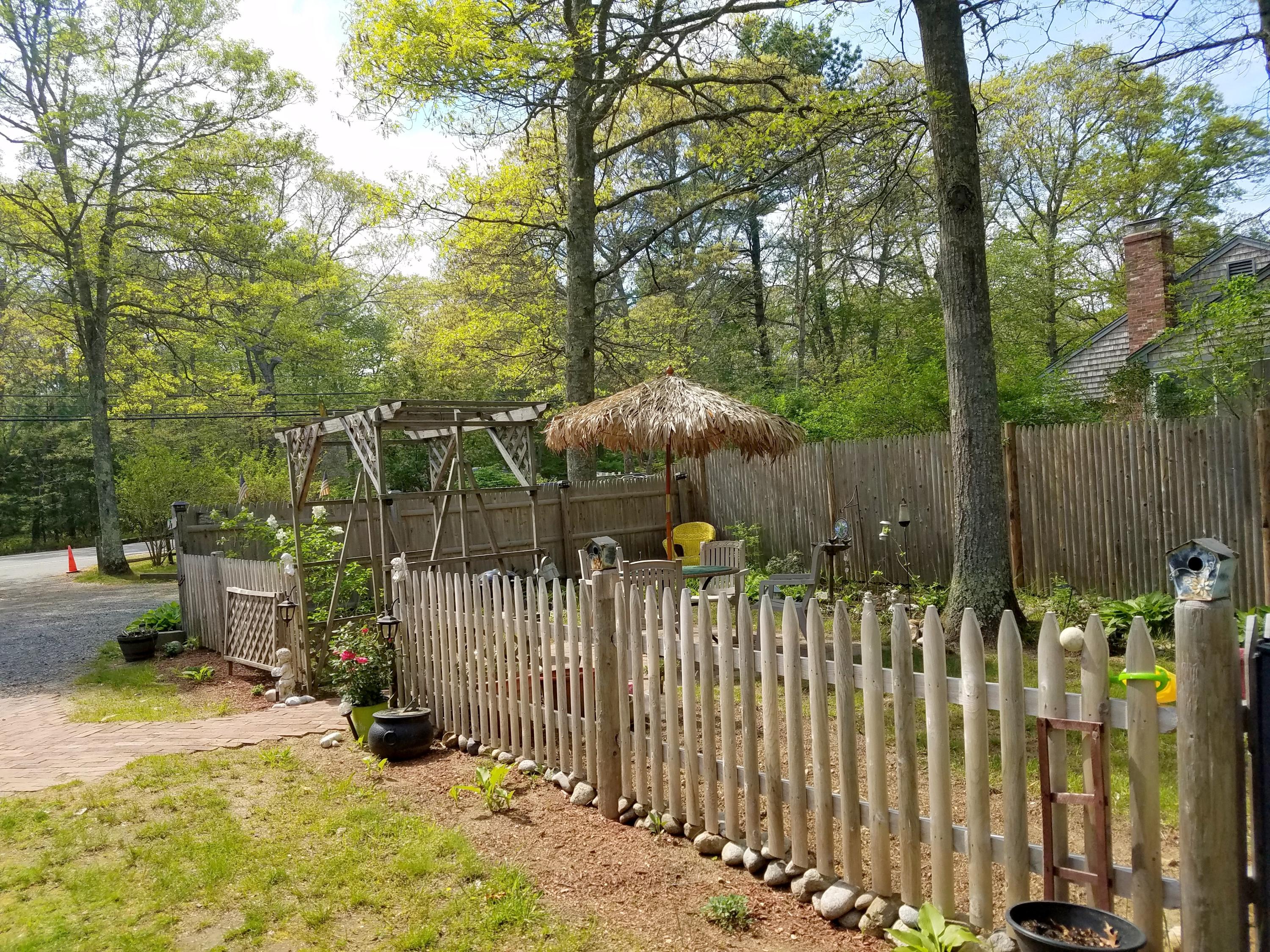 835 Cotuit Road Mashpee, MA 02649 - Photo 2 of 14 a view of a fence and trees