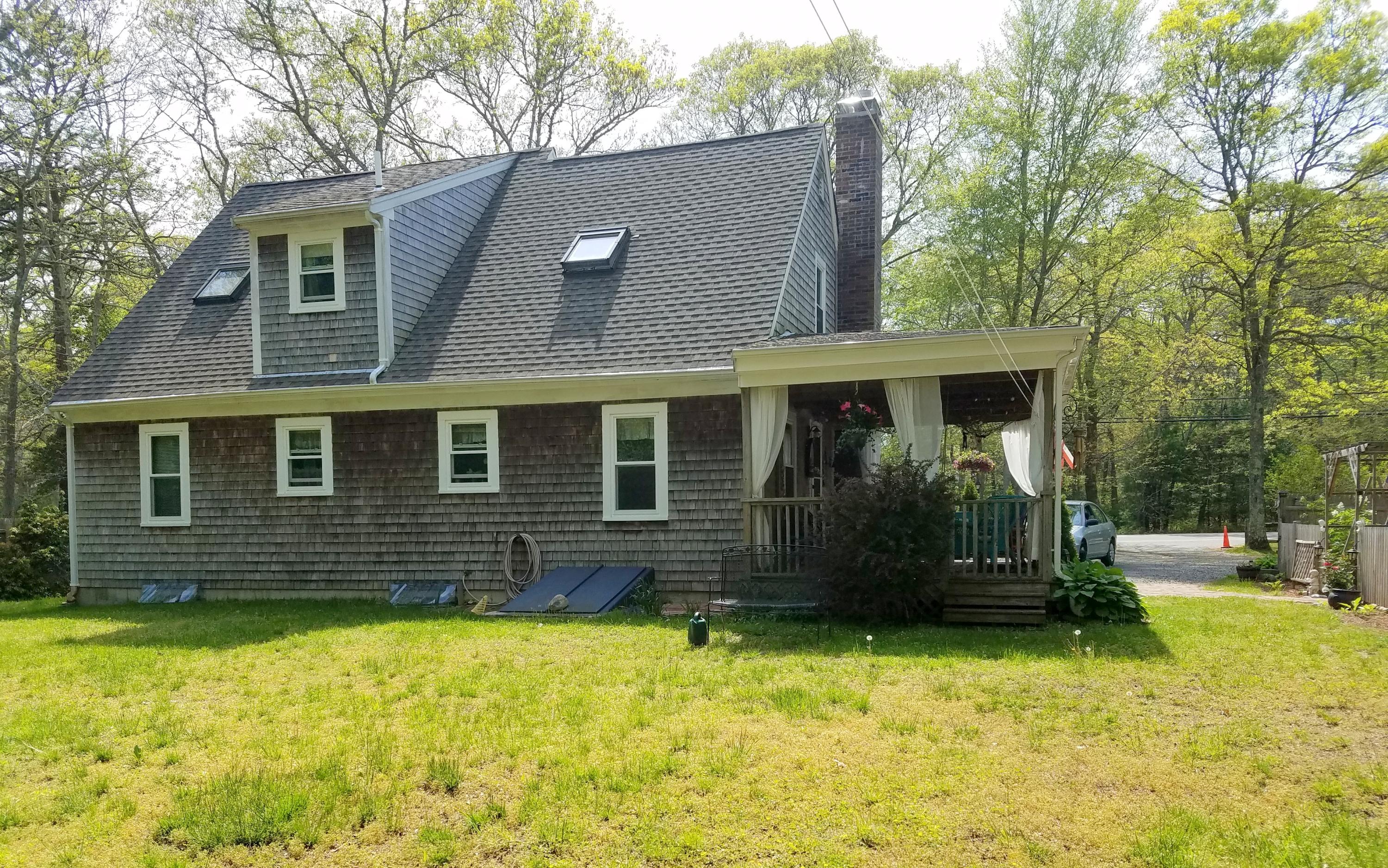 835 Cotuit Road Mashpee, MA 02649 - Photo 4 of 14 a front view of a house with a yard
