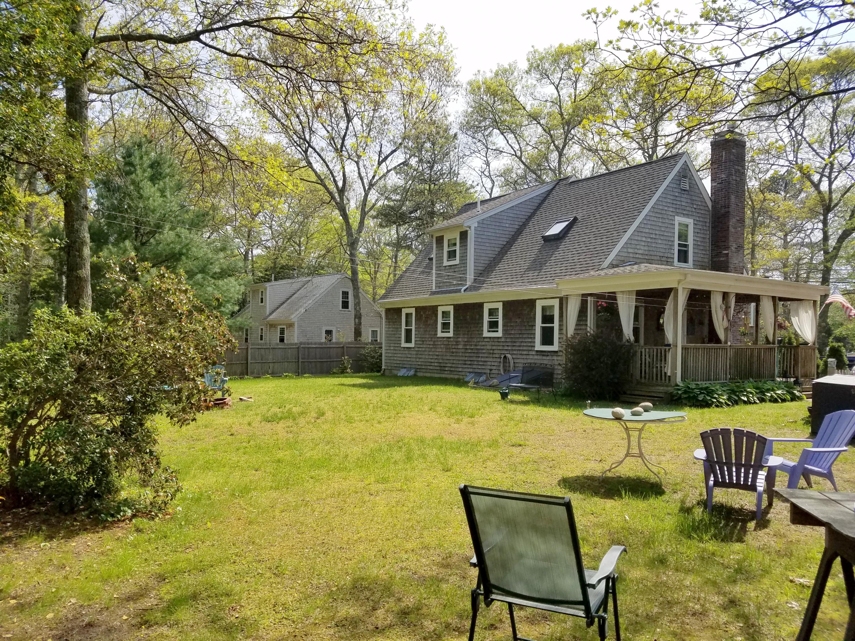 835 Cotuit Road Mashpee, MA 02649 - Photo 5 of 14 a view of a house with a backyard