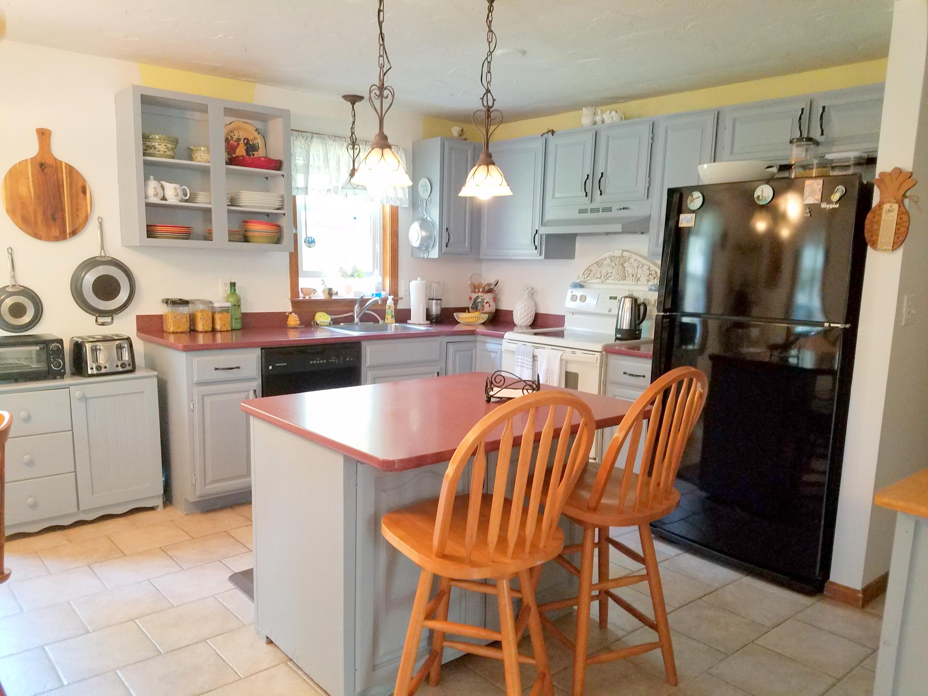 835 Cotuit Road Mashpee, MA 02649 - Photo 7 of 14 a kitchen with stainless steel appliances granite countertop a sink a stove and a refrigerator