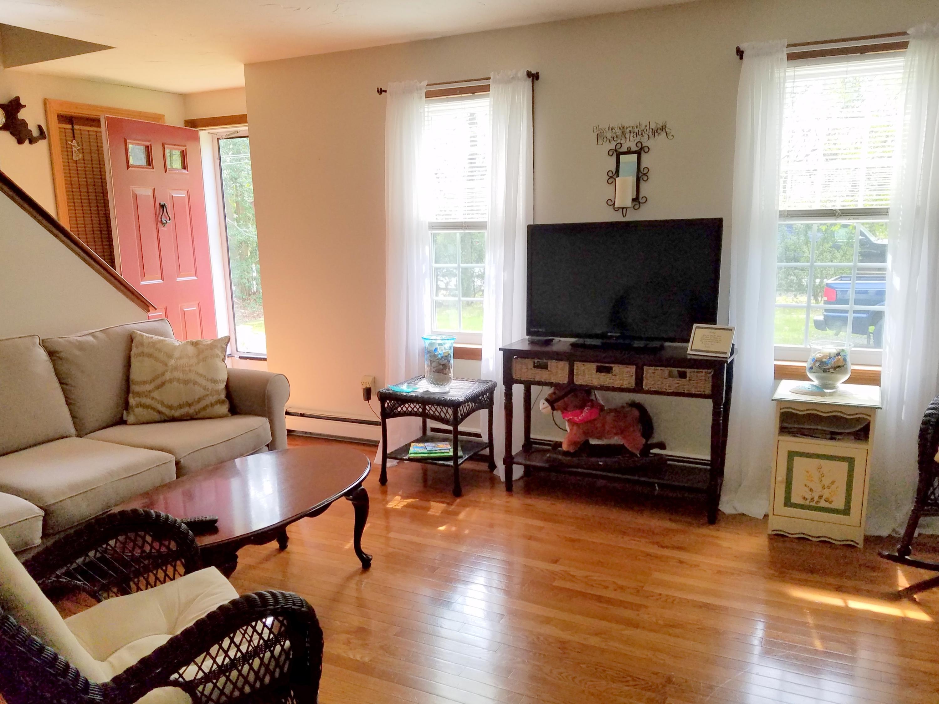 835 Cotuit Road Mashpee, MA 02649 - Photo 10 of 14 a living room with furniture and a flat screen tv