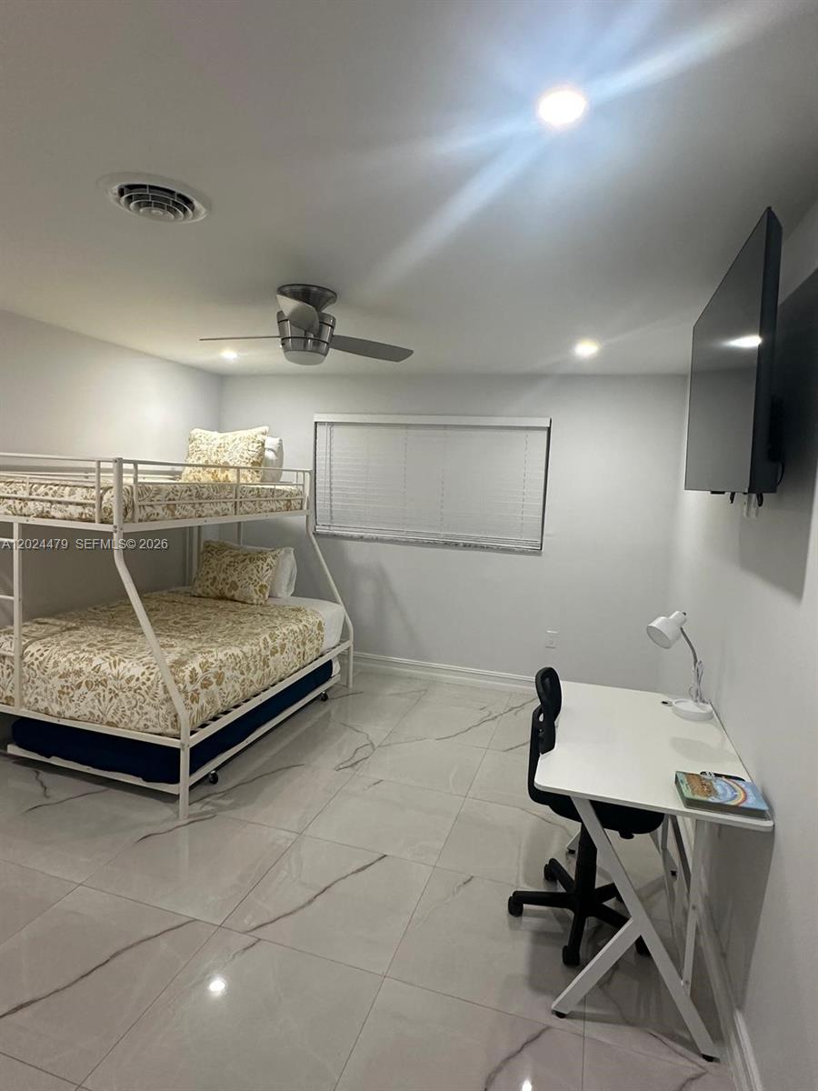 2212 Club House Road North Fort Myers, FL 33917 - Photo 22 of 40 a bedroom with a bed and a table in it