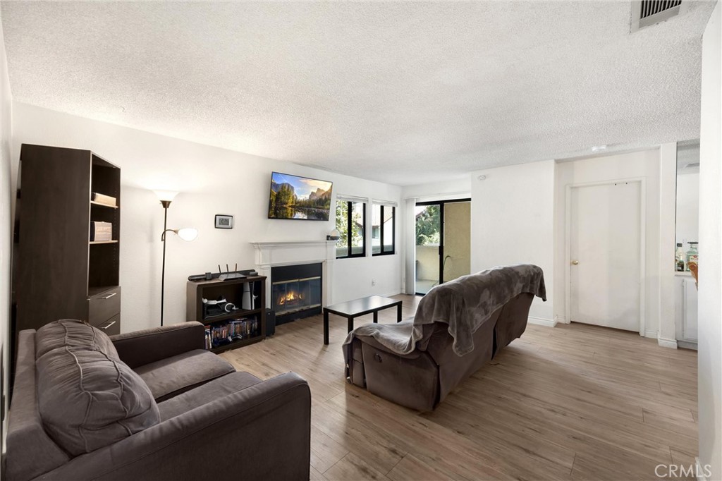 8333 Vineyard Avenue, Unit 4 Rancho Cucamonga, CA 91730 - Photo 2 of 22 a living room with furniture and a fireplace