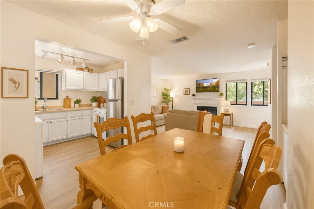 8333 Vineyard Avenue, Unit 4 Rancho Cucamonga, CA 91730 - Photo 3 of 22 a living room with stainless steel appliances furniture a chandelier and a dining table