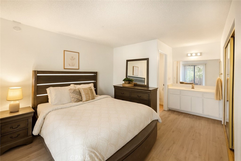 8333 Vineyard Avenue, Unit 4 Rancho Cucamonga, CA 91730 - Photo 7 of 22 a bedroom with a bed and a view of kitchen