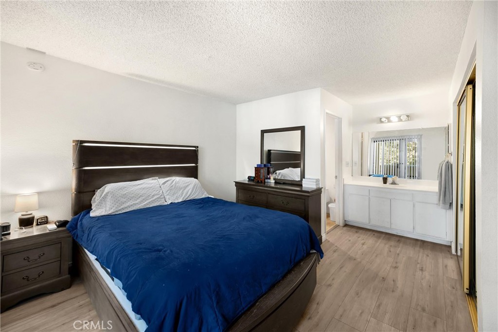 8333 Vineyard Avenue, Unit 4 Rancho Cucamonga, CA 91730 - Photo 8 of 22 a bedroom with a bed and a view of kitchen