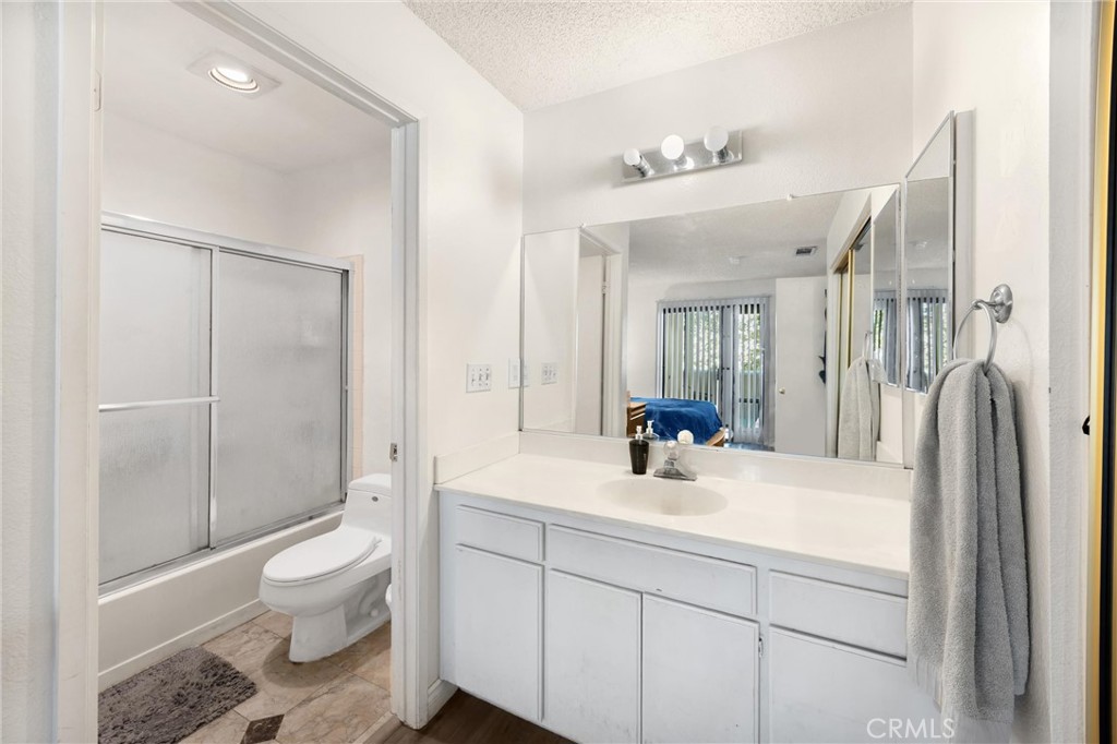 8333 Vineyard Avenue, Unit 4 Rancho Cucamonga, CA 91730 - Photo 10 of 22 a bathroom with a sink a toilet and shower