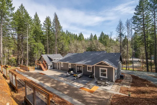 an aerial view of a house with yard and entertaining space