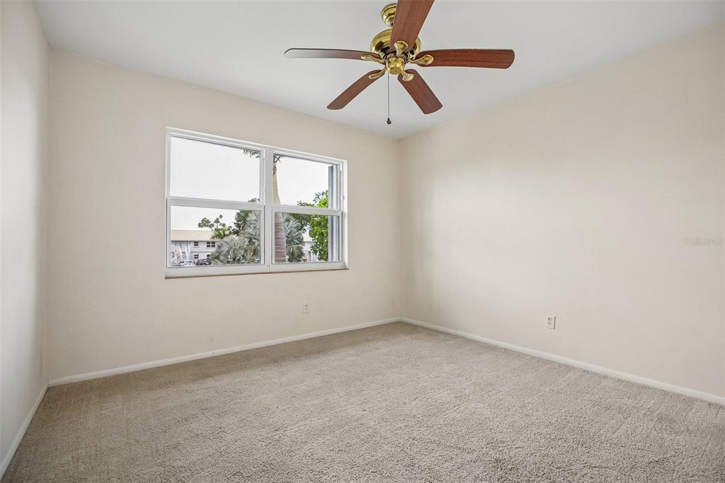 26485 Rampart Boulevard, Unit A27 Punta Gorda, FL 33983 - Photo 15 of 27 an empty room with a window and a fan