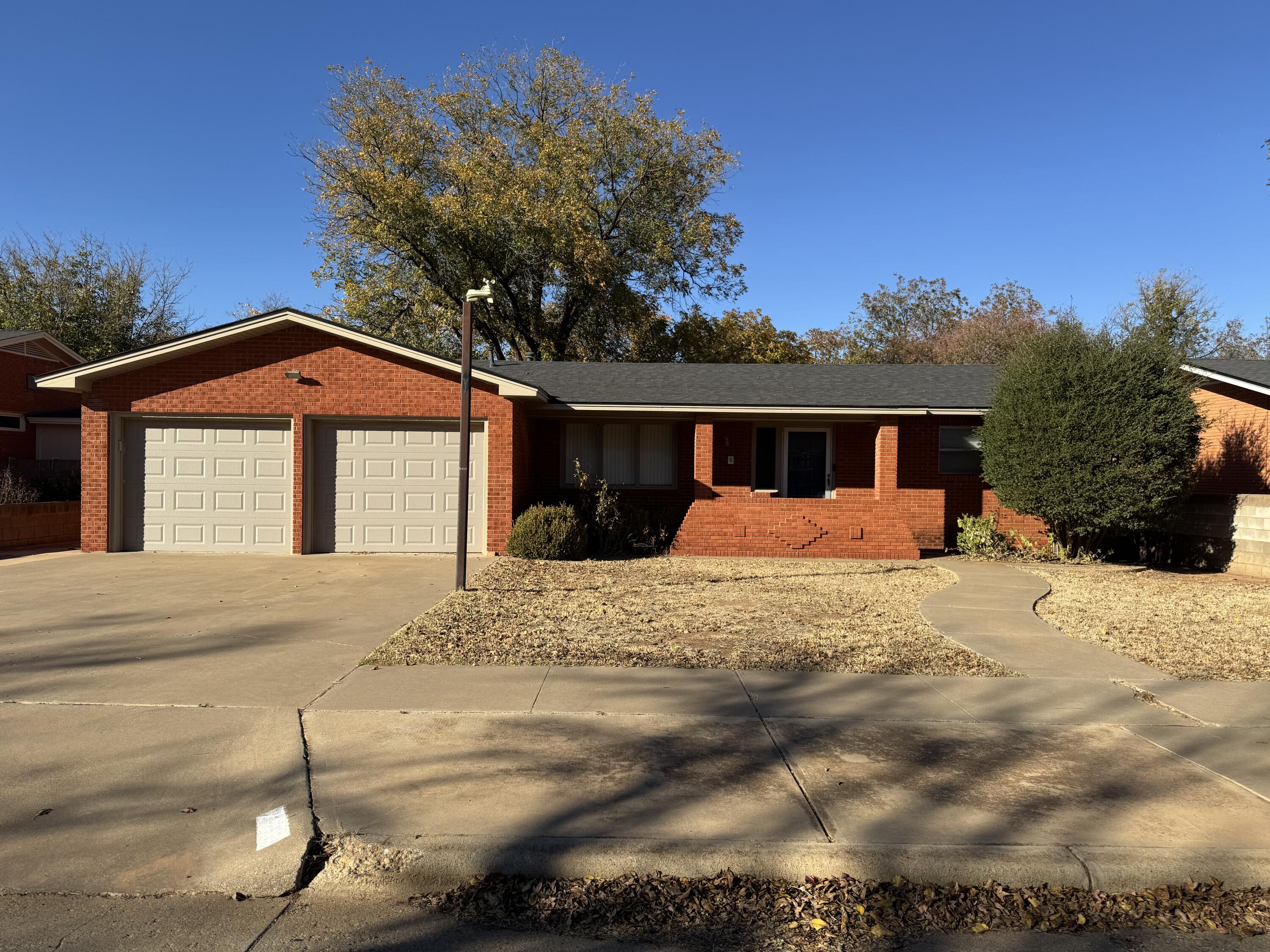 2208 South 4th Street Lamesa, TX 79331 - Photo 1 of 36 a front view of a house with a yard